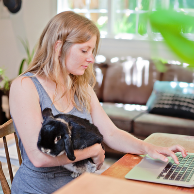 Lady with rabbit on her knee while working